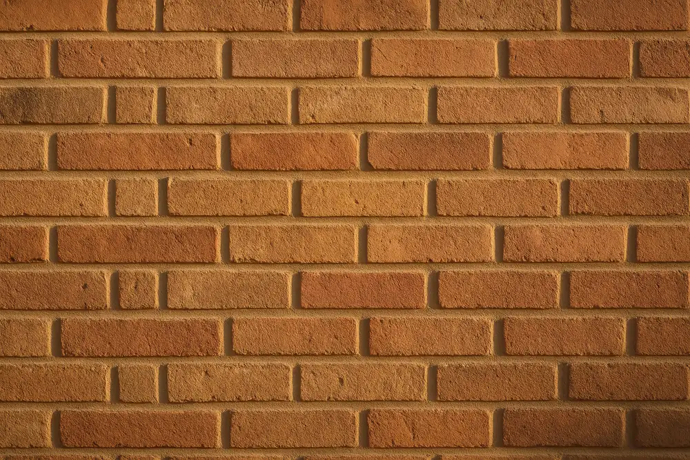 A finished wall section with even, slightly recessed joints in warm light — heritage repointing, Ballarat. Illustrative example.